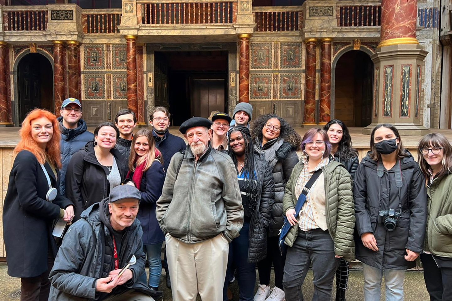 Sarah Gaetano (red scarf), a sophomore studying theatre acting with a design and technology minor, in front of the stage at Shakespeare鈥檚 Globe Theatre in London