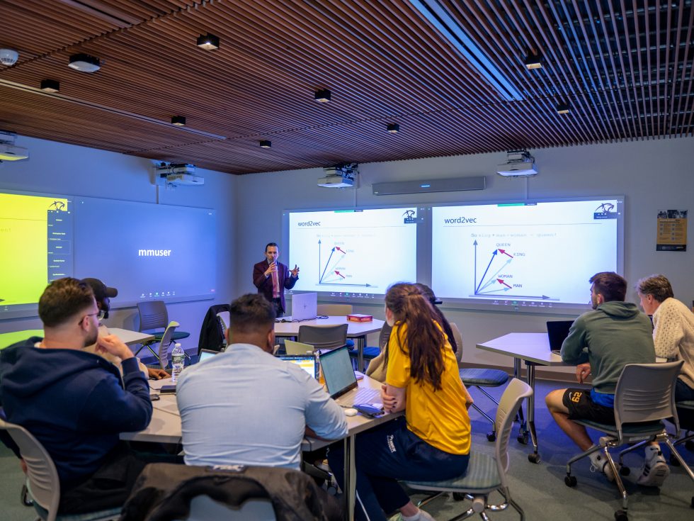 Juan Jaramillo, PhD, associate professor of decision sciences, leads a discussion in Adelphi鈥檚 Innovation Center. Students are encouraged to use Natural Language Process concepts learned in the classroom to create concrete innovative solutions to real problems.