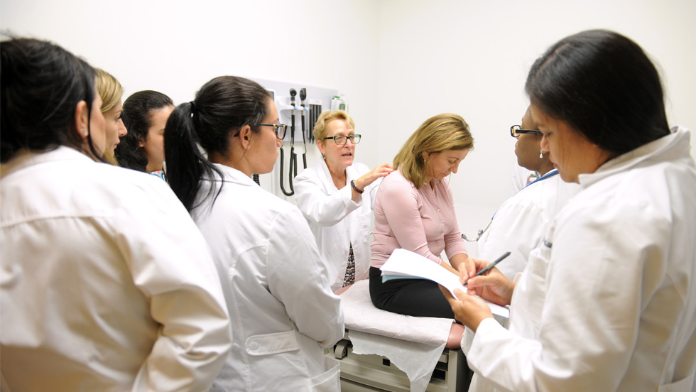 Faculty provides hands-on learning opportunities to a group of nursing students.